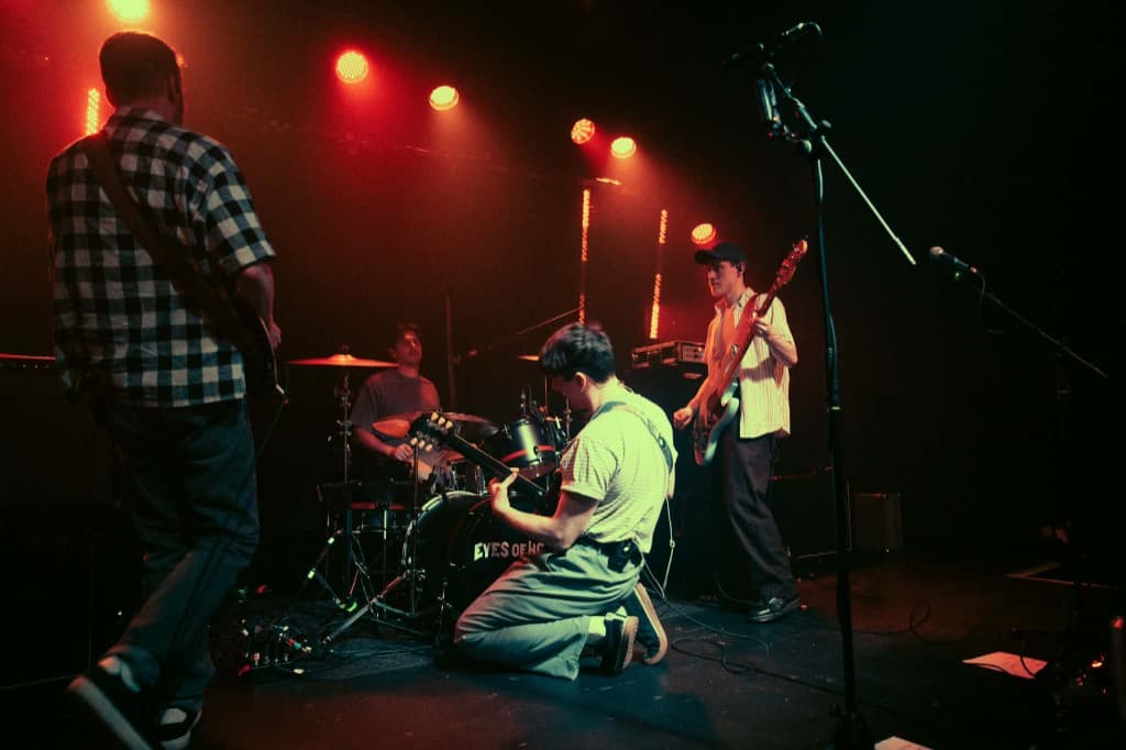 Eyes of Home performing live under red stage lights